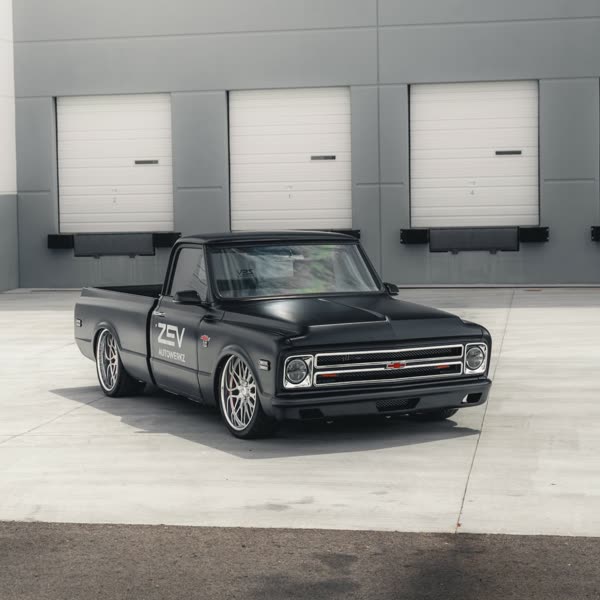 Black 1967 C10 pickup outside the shop